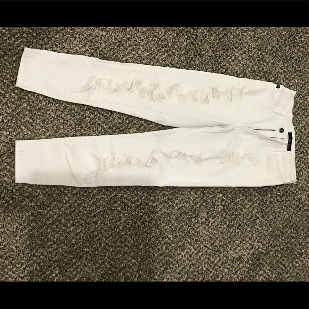 Shredded white jeans